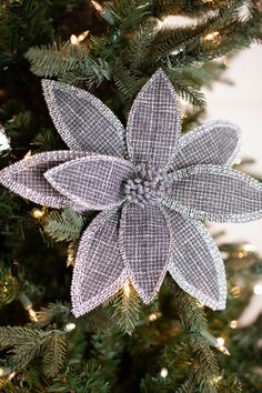 an ornament hanging from the top of a christmas tree