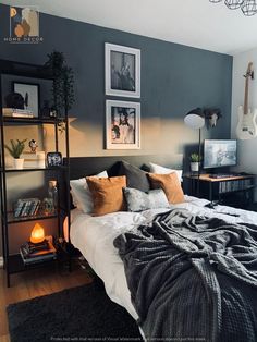 a bedroom with gray walls and pictures on the wall