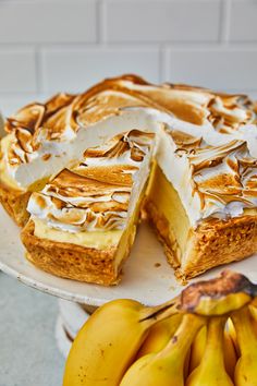 a cake on a plate with bananas around it