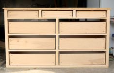 an unfinished dresser with drawers in the middle