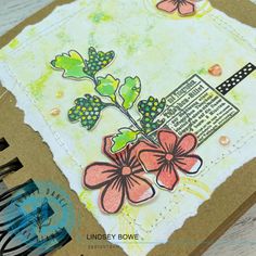 a close up of a card with flowers and words on the front, along with an ink pen