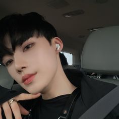 a young man sitting in the back seat of a car with his hand on his shoulder