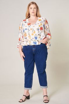 Sunkissed by primary colored floral motifs. A dream garden floral print shapes this elegant blouse with voluminous balloon sleeves and V neckline. It maintains a blouson bodice shaped by an elastic waist to create a semi peplum silhouette. Pair the look with medium washed denim and brown sandals for a casual day out.- Elastic waist- Peplum- Cropped- Lined- Color: Floral PrintSize + Fit - Model is 5'9" and wearing size 2X- Measurements taken from size 2X - Chest: 52"- Length: 24 1/2" Fabric Self: Balloon Sleeve Blouse, Elegant Blouses, Tiered Maxi Dress, Washed Denim, Brown Sandals, Floral Motifs, Balloon Sleeves, Dream Garden, Sweater Weather