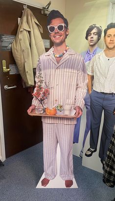 a man is holding a tray with food on it