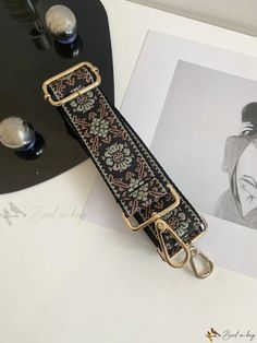 a black and gold strap with flowers on it, next to a photograph of a woman