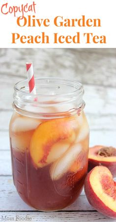 a mason jar filled with peach iced tea next to sliced peaches and a striped straw