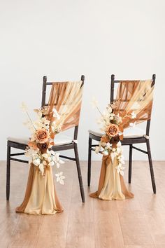 two chairs with flower arrangements on them sit side by side in front of a white wall