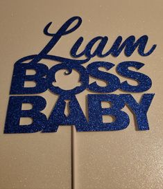 a blue cake topper that says, i am boss baby on it's side