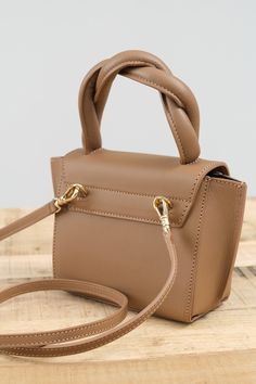 The Montalbano Mini Handbag. With a twisted handle, this mini bag is the perfect accessory to hold your daily essentials. It can be worn cross body, or on your arm with the detachable body strap. With canvas lining and a leather exterior, this mini handbag is the perfect addition to your fall wardrobe. Versatile Brown Satchel For Evening, Versatile Brown Evening Satchel, Trendy Brown Box Bag With Handle Drop, Chic Brown Handheld Box Bag, Chic Brown Shoulder Bag With Adjustable Handle, Brown Shoulder Bag With Adjustable Handle For Evening, Chic Brown Bags With Adjustable Handle, Brown Evening Shoulder Bag With Adjustable Handle, Brown Evening Bag With Adjustable Handle