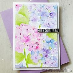 a card with watercolor flowers on it, and the words have a delightful day