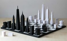 a black and white chess board with skyscrapers on it