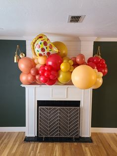 a bunch of balloons are on top of a fireplace