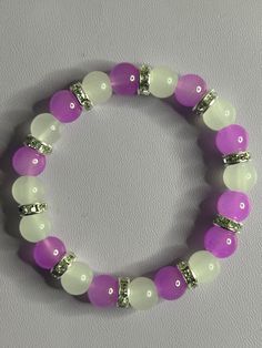 Cute plain purple and white braclet. Purple And White Bracelet, Pink And Purple Bracelet, White Beaded Round Wristband, White Crystal Bracelet With Colorful Round Beads, Purple Stretch Bracelet With Colorful Beads, Purple Bracelet With Colorful Beads, Purple Bracelets With Colorful Round Beads, White Beaded Round Bracelets, White Stretch Bracelet With 8mm Beads