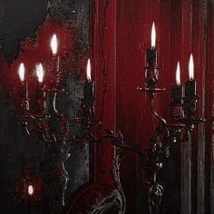 a red wall with some candles in it