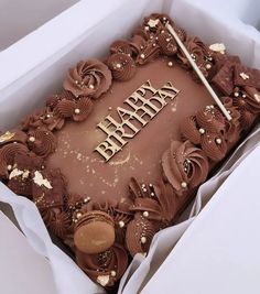 a chocolate birthday cake in a box with the word happy on it's side