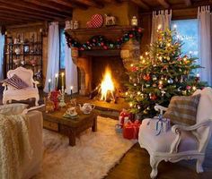 a living room filled with furniture and a christmas tree in front of a fire place