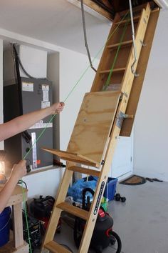 a woman standing next to a wooden easel