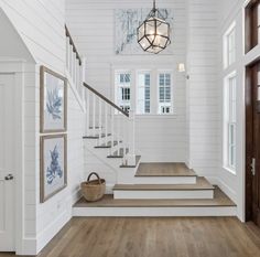 a white house with wood floors and stairs