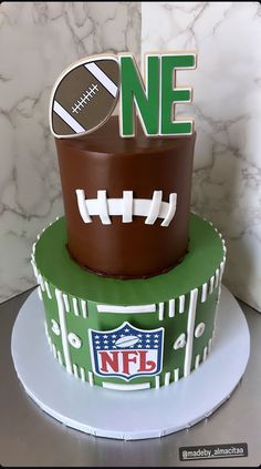 a football themed cake with the number one on top