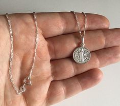 "925 STERLING SILVER SAINT BENEDICT NECKLACE 20\" LONG... FOR GOOD LUCK ,PROSPERITY AND PROTECTION. MADE IN ITALY-BEST QUALITY PENDANT : 24 mm X 15 mm CADENA DE SAN BENITO EN 925 PLATA ESTERLINA 20\" LARGO .. PARA PROSPERIDAD, BUENA SUERTE Y PROTECCION. HECHO EN ITALIA-MEJOR CALIDAD DIJE: 24 mm X 15 mm" Sterling Silver Charm Necklaces With Hallmarked Round Pendant, Sterling Silver Charm Necklaces With Round Pendant, White Gold Sterling Silver Charm Necklace, White Gold Sterling Silver Necklace With Charms, Dainty Silver Charm Necklace Stamped 925, Sterling Silver Charm Necklaces, Silver Charm Necklace With Round Pendant Stamped 925, Silver Charm Necklace With 925 Stamp And Round Pendant, Silver Round Pendant Charm Necklace Stamped 925