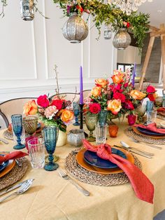 the table is set with plates and place settings