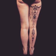 a woman's legs with tattoos on them and the bottom part of her leg