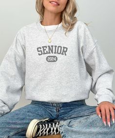 Perfect comfy sweatshirt for a Class of 2024 senior.  Check out our other listings for even more varieties! A unisex heavy blend crewneck sweatshirt. This garment is made from polyester and cotton. This combination helps designs come out looking fresh and beautiful. The collar is ribbed knit, so it retains its shape even after washing. There are no itchy side seams on these sweaters. Made using 100% ethically grown US cotton. See the size chart in the pictures. The sizes are based a normal unise Gray Letter Print Sweatshirt For Campus, Varsity Long Sleeve Sweatshirt For College Events, Fall Letter Print Sweatshirt For College Events, Gray Relaxed Fit Sweatshirt For Campus, School Spirit Crew Neck Sweatshirt For College Events, School Spirit Long Sleeve Sweatshirt For College Events, School Spirit Sweatshirt With Letter Print For College Events, School Spirit Sweatshirt For College Events, Long Sleeve School Spirit Sweatshirt For College Events