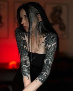 a woman with tattoos on her arms and arm