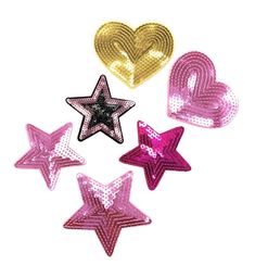 five star shaped sequins with hearts and stars on the top one is pink