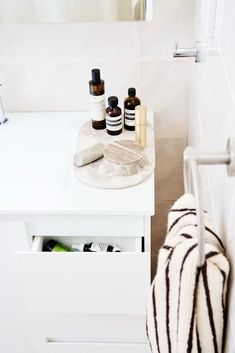 a bathroom vanity with several bottles on it