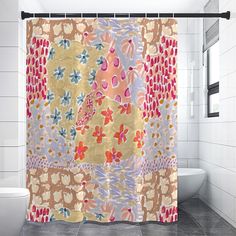 a colorful shower curtain in a bathroom