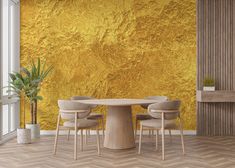 a dining table with four chairs and a potted plant in front of a yellow wall