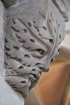 a close up view of the corner of a building with an intricate design on it