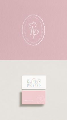 two business cards with the letter kp on them, one in pink and one in white