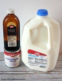 two gallon jugs of milk next to each other on a wooden table with a white wall in the background