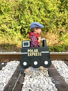 a small child riding on top of a toy train