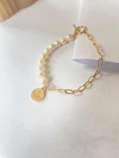 This bracelet is made of freshwater pearl and Paperclip chain. The delicate design and soft colour make it a symbol of tenderness, while the sturdy materials and edgy details add a touch of toughness. Whether you are going for a casual look or dressing up for a special occasion, this bracelet is versatile accessory that will add a unique touch to your style. Freshwater Pearl size is 5mm Paperclip is 14k gold filled Trendy Pearl Bracelet With Pearl Charm, Trendy Pearl Bracelets With Pearl Chain, Trendy Pearl Bracelet With Pearl Chain, Everyday Pearl Bracelet With Pearl Charm, Everyday Pearl Charm Bracelet, Modern Pearl Bracelet With Charm As A Gift, Trendy Pearl Bracelets With Pearl Charm, Trendy Pearl Charm Bracelets, Modern Pearl Bracelet With Pearl Charm As Gift