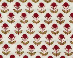 a red and green flower pattern on white fabric