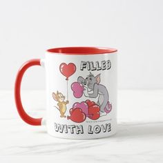 a red and white coffee mug with an image of two cats holding balloons in the shape of hearts