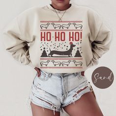 Celebrate the holiday season with our playful Dachshund Ugly Christmas, Unisex Gildan 180 sweatshirt! This festive design features a charming doxie dog in a pixelated Christmas theme, capturing the spirit of the season in a unique, retro style. Perfect for dog lovers and Christmas enthusiasts alike, this sweater will add a touch of fun and warmth to your holiday wardrobe. .: 50% cotton, 50% polyester  .: Medium-heavy fabric (8.0 oz/yd² (271.25 g/m .: Loose fit  .: Sewn-in label  .: Runs true to Winter Crew Neck Top With Dog Print, Winter Dog Print Crew Neck Top, Doxie Dog, Washing And Drying Machine, Doxie Mom, Mom Sweater, Gift For Dog Lover, Festive Design, Holiday Shirt