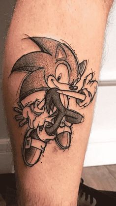 a man's leg with a black and white cartoon character tattoo on the calf