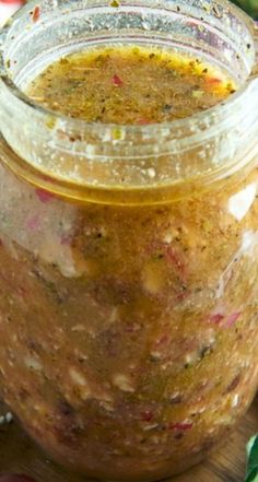 a jar filled with food sitting on top of a wooden table