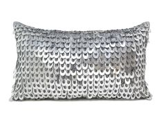 a silver sequin pillow on a white background