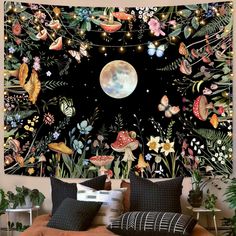 a bedroom with a large wall tapestry decorated with flowers and butterflies in front of a full moon