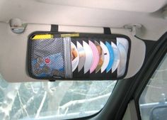 the inside of a car with various items hanging from it's side window and in front of another car