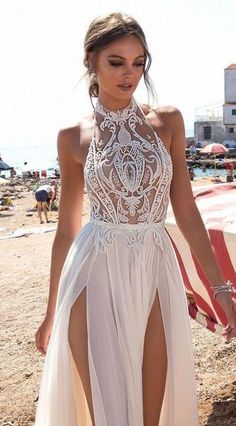 a woman in a white dress on the beach