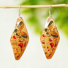 Add a touch of springtime joy to your looks with this colorful set of dangle earrings by Rosy and Daniel. They're crafted from copper and hand-painted with monarch butterflies and floral motifs in gold orange moss green and carnation. Whimsical Hand Painted Earrings, Hand Painted Dangle Jewelry, Hand Painted Jewelry For Spring, Hand Painted Jewelry As Spring Gift, Spring Hand Painted Jewelry, Hand Painted Jewelry For Spring Gift, Orange Earrings For Spring Gift, Multicolor Hand Painted Earrings For Summer, Hand Painted Multicolor Earrings For Summer