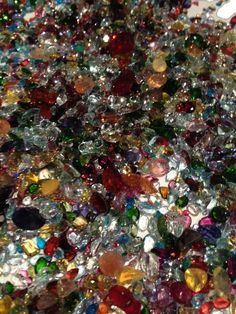 many different colored glass beads are scattered together