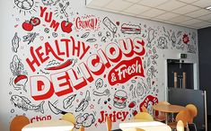 a wall mural in a cafeteria with the words healthy delicious and fresh painted on it