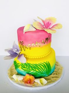 there is a multi layer cake with flowers on it